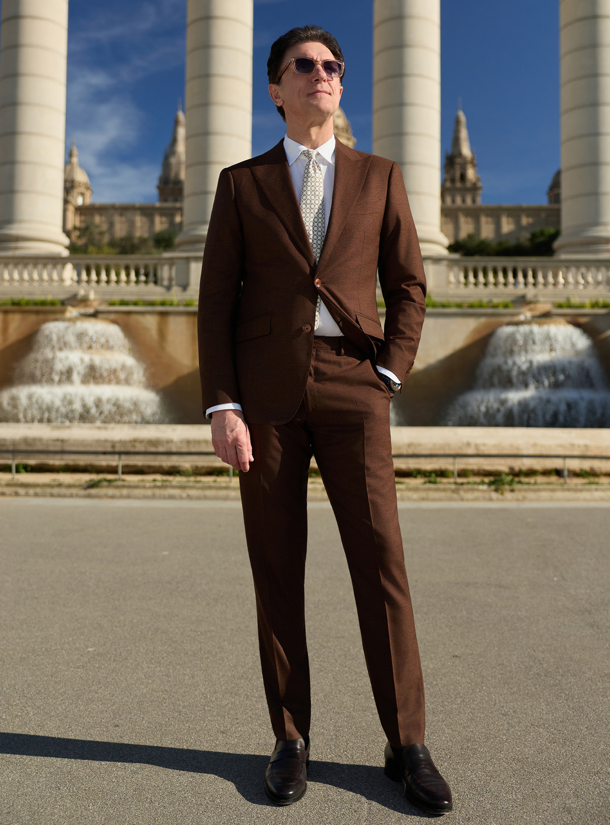 Dark brown Consiglieri suit with a white shirt and light patterned tie
