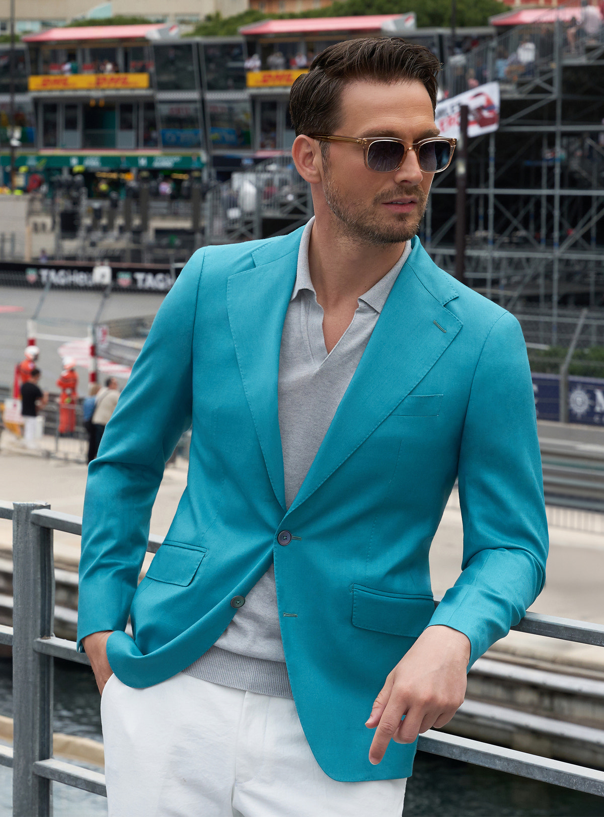 Turquoise Consiglieri jacket worn with a white shirt and ivory trousers