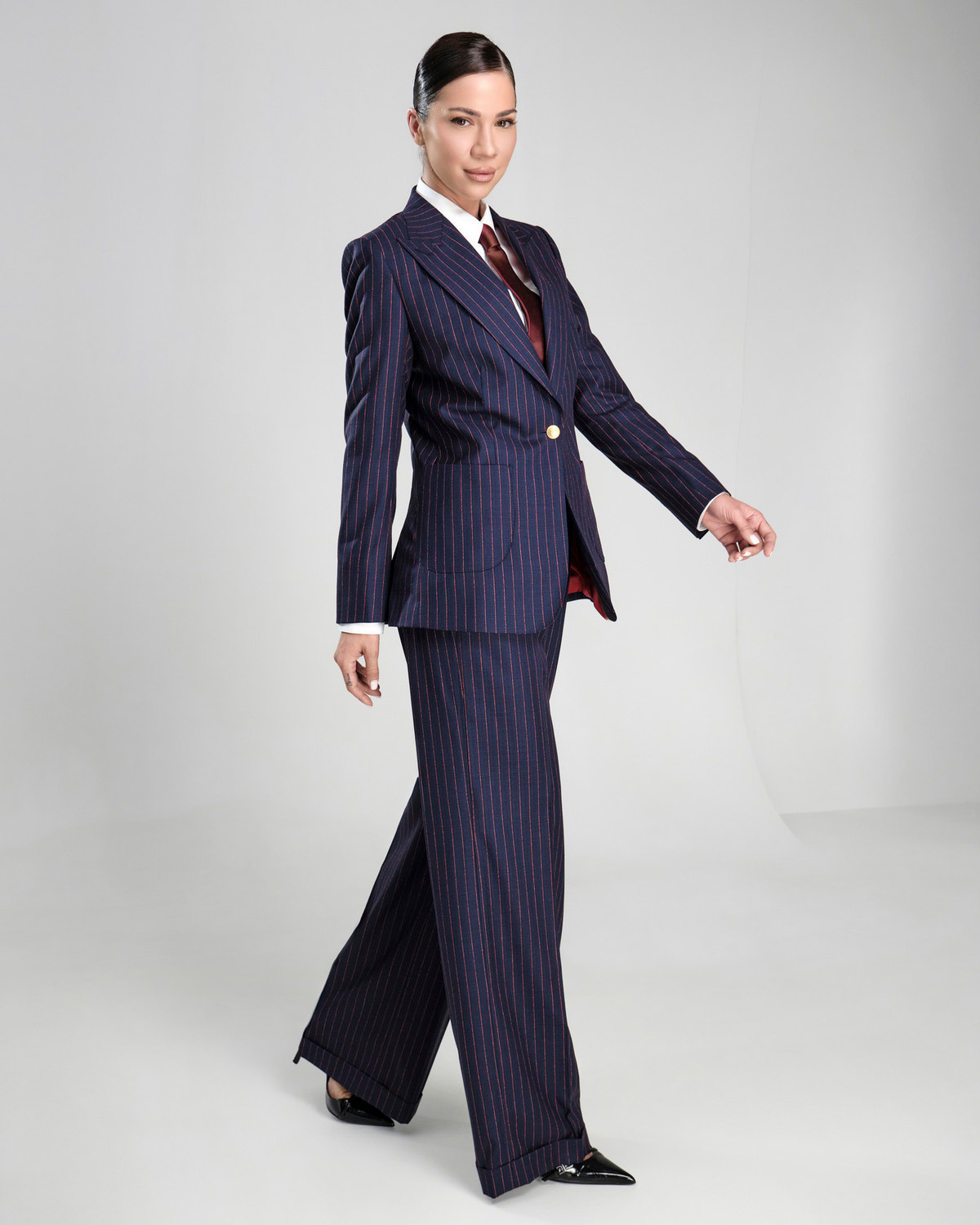 Navy pinstriped Consiglieri DONNA women's suit with a white shirt and burgundy tie