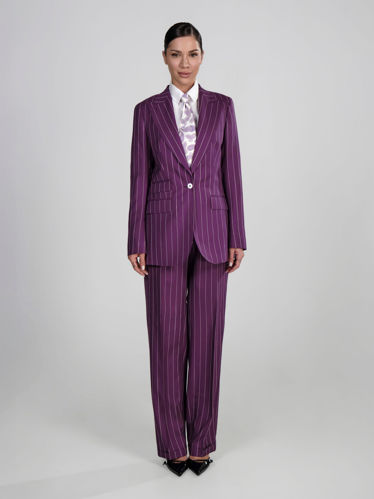 Purple pinstriped Consiglieri DONNA women's suit worn with a patterned shirt