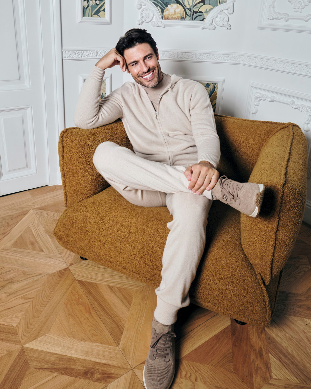Beige Consiglieri sweater with a short zip, styled with white trousers