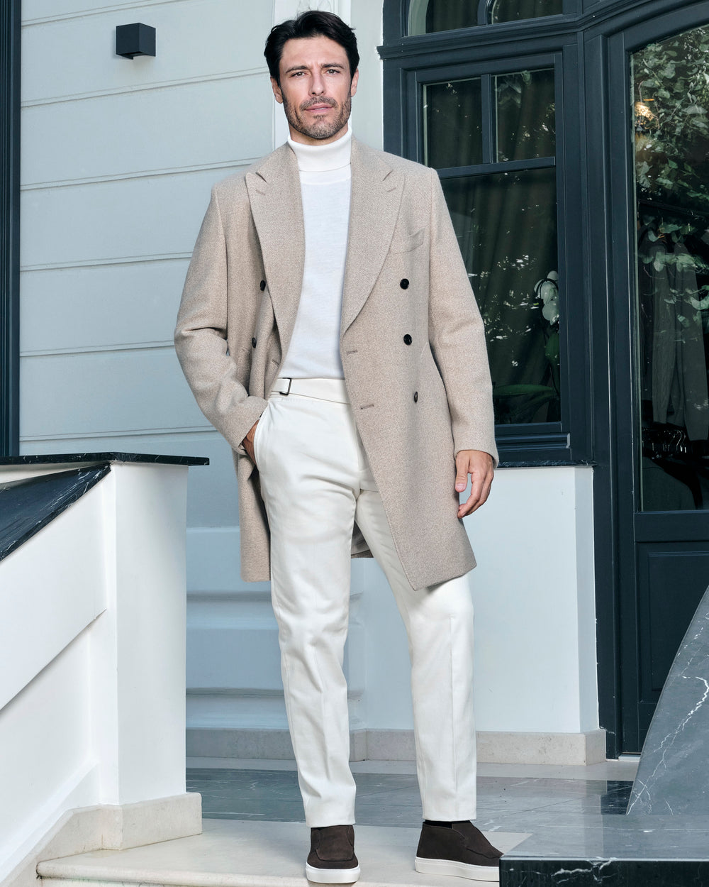Light beige double-breasted Consiglieri overcoat with a light turtleneck and trousers