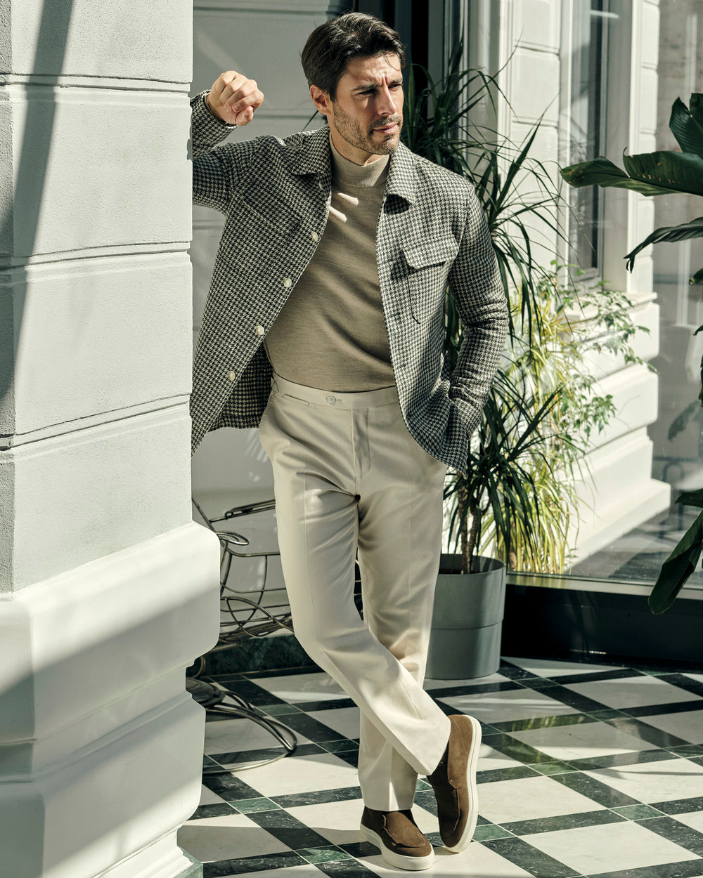 Consiglieri jacket with a small check, worn with a beige turtleneck and cream trousers