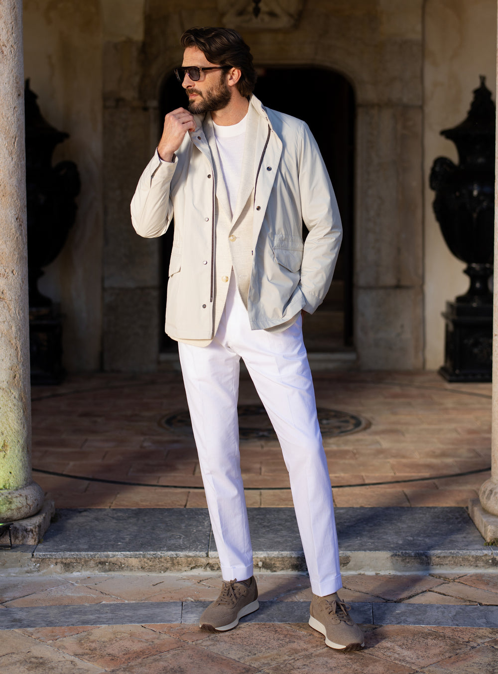 Light grey Consiglieri four-pocket jacket worn with a white T-shirt and white trousers