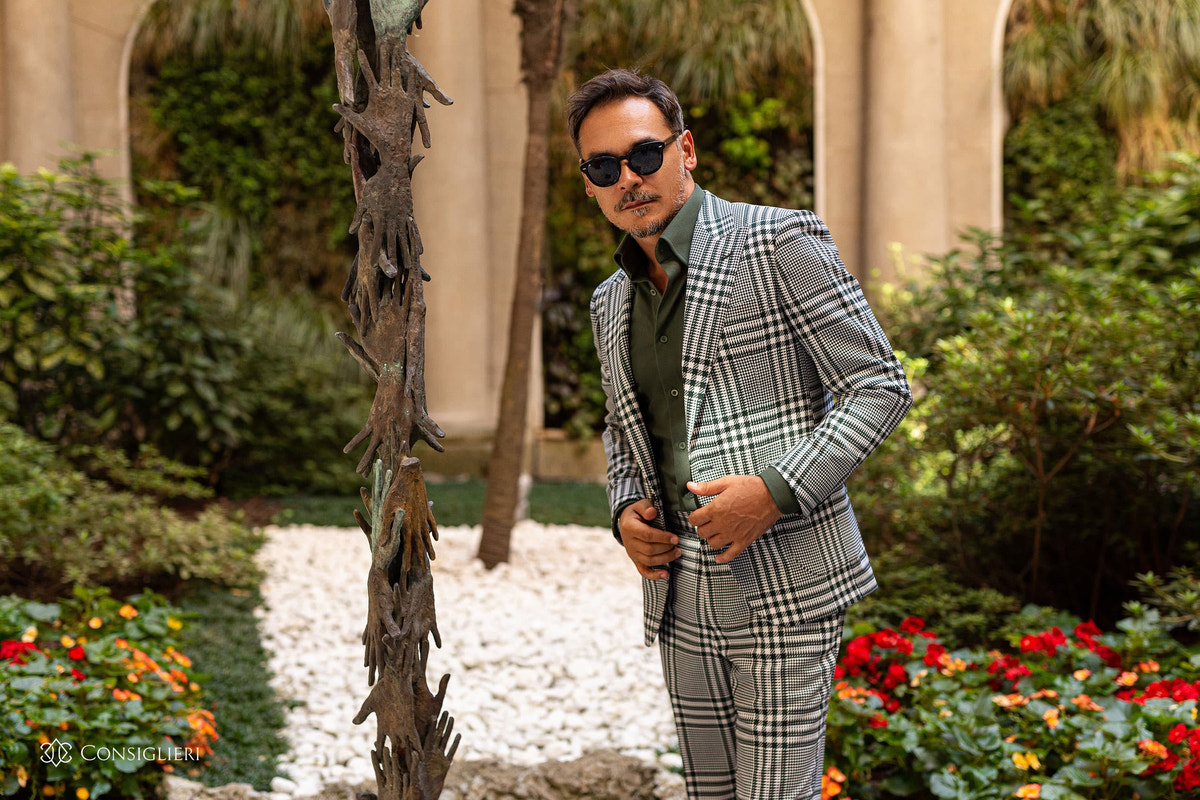 Small-check Consiglieri suit with a green shirt in a garden