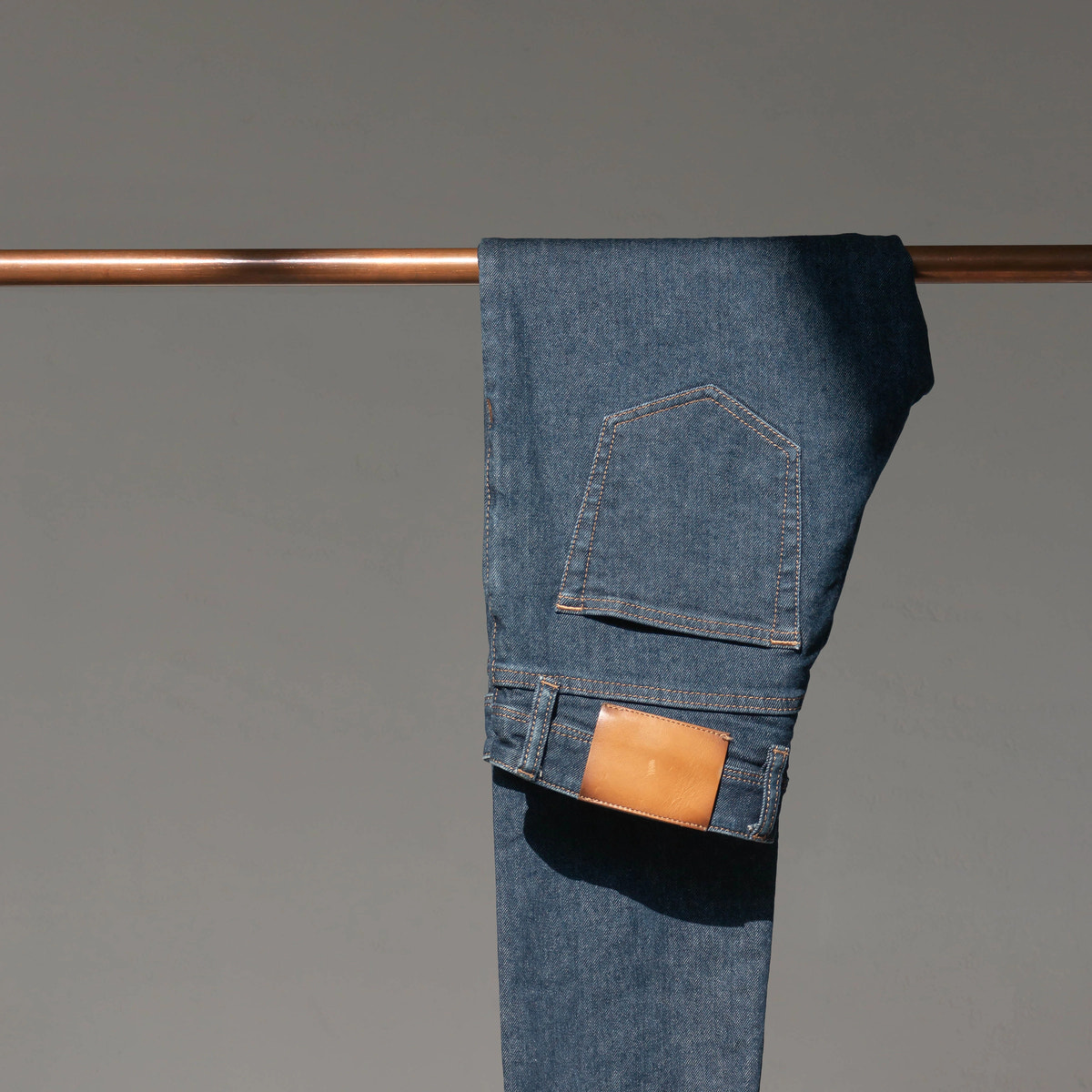 Deep indigo denim, pocket and tobacco stitching — Custom Made Jeans detail.