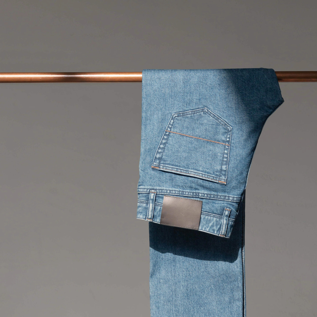 Light washed blue denim, pocket and stitching — Custom Made Jeans detail.