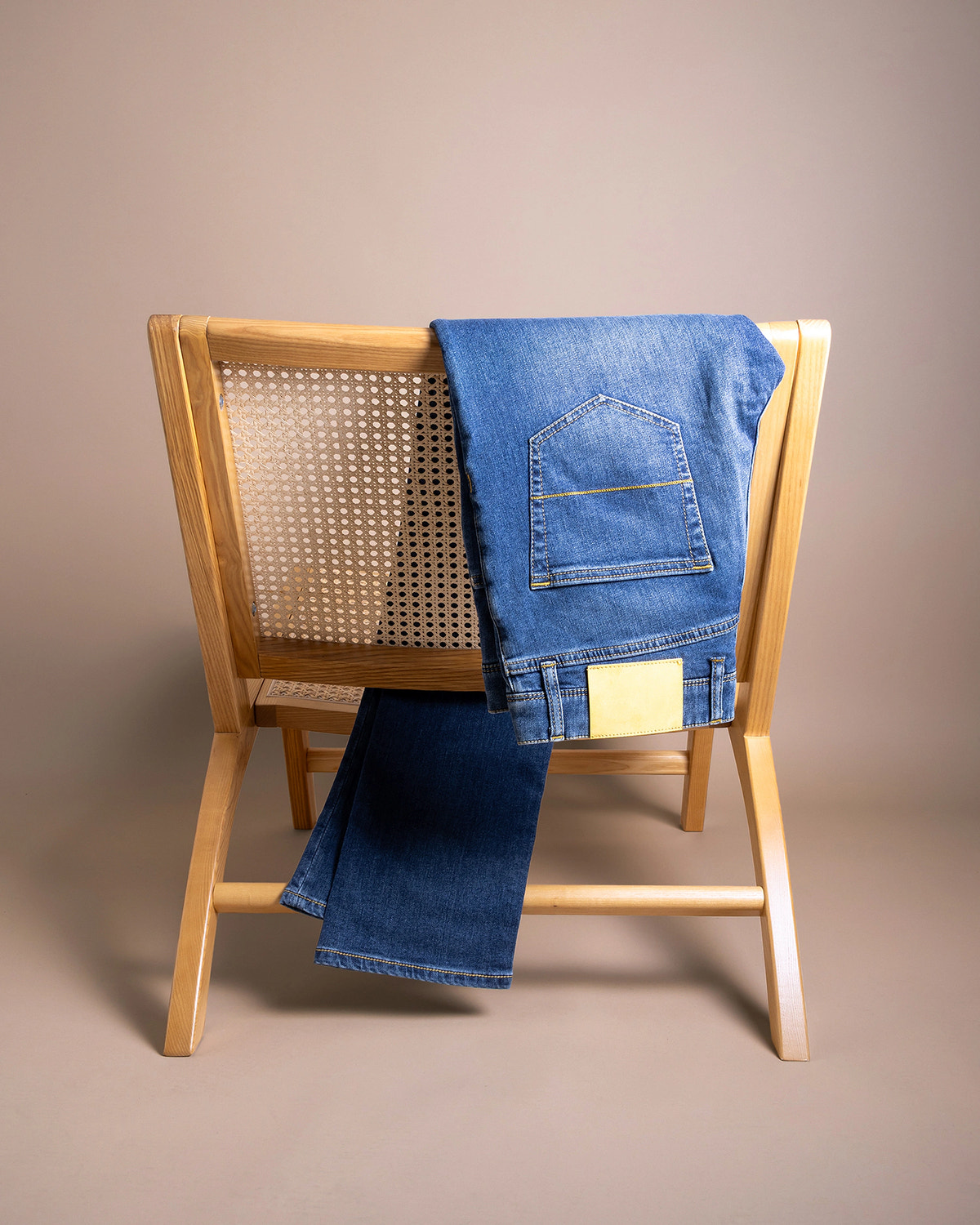 Bright blue denim, pocket with golden stitching and a light-coloured patch.