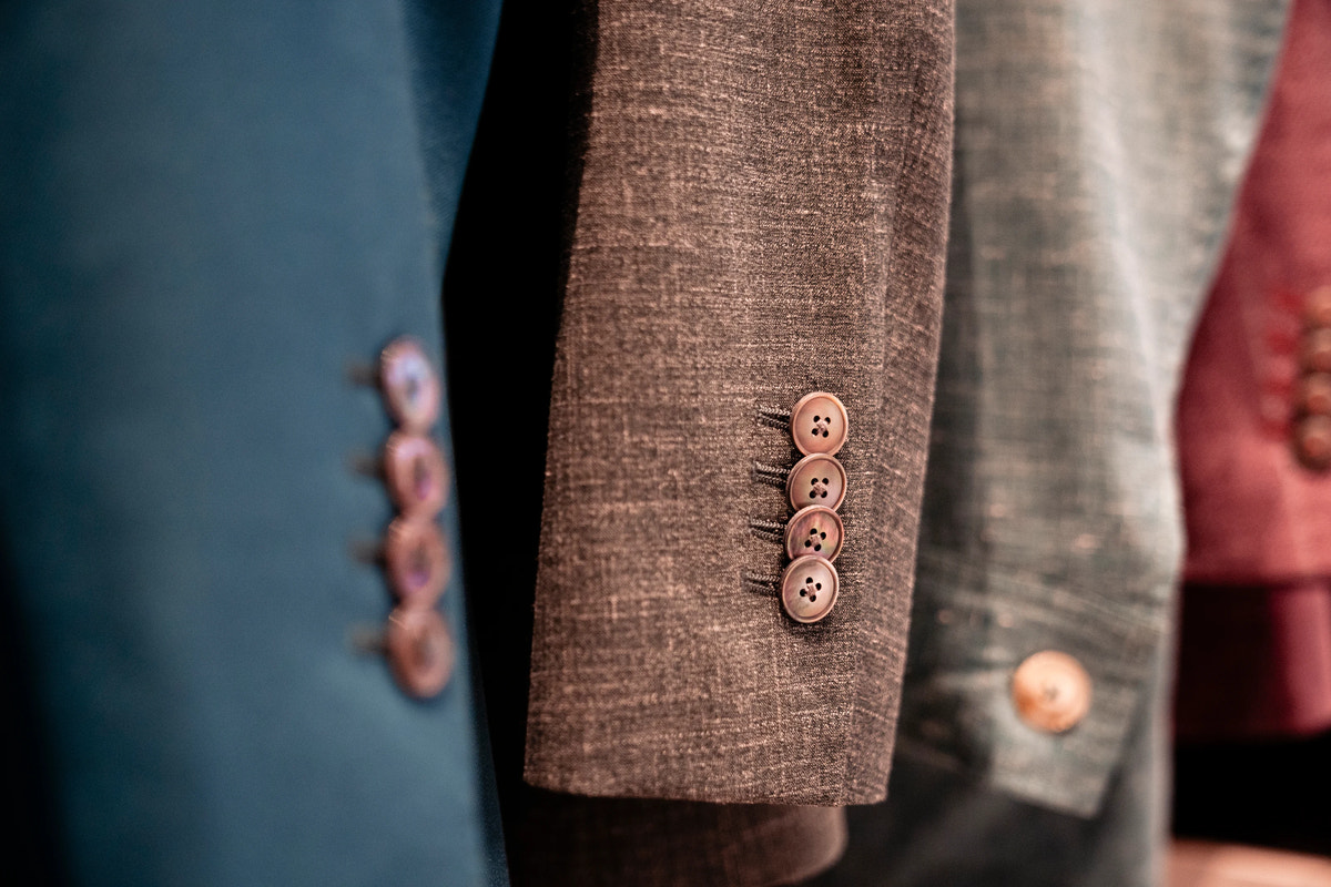 A jacket cuff with a row of buttons.