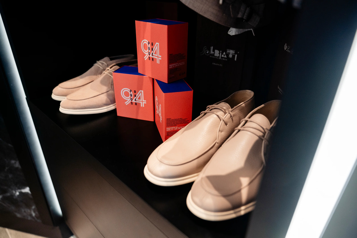 Beige lace-up footwear with white soles, shown in detail.