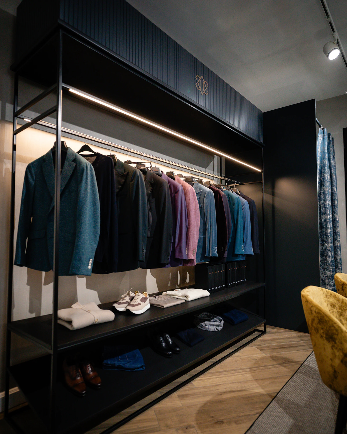 Blue and neutral-toned jackets displayed above a selection of shoes.