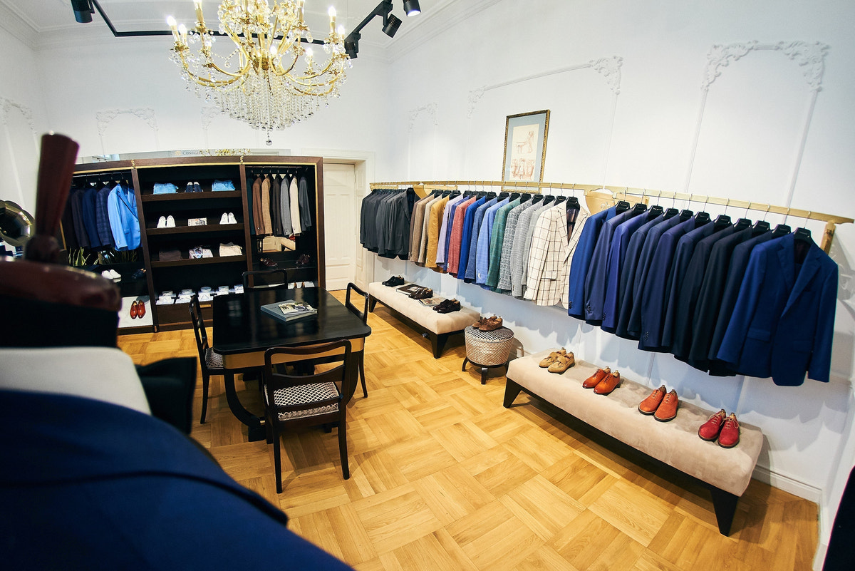 Jackets in navy, grey and beige, alongside shirts and shoes.