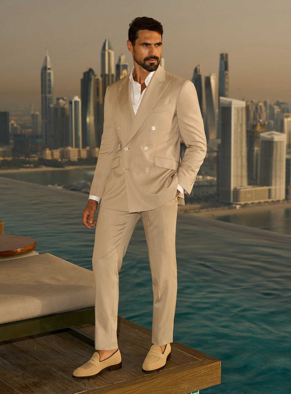 Beige suit and white shirt on a terrace overlooking the city