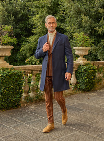 Consiglieri: navy overcoat over a cognac striped suit and ivory roll-neck