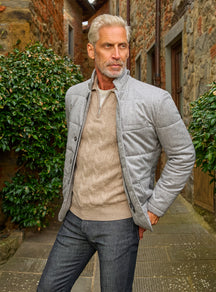 Consiglieri: light grey quilted jacket with a beige sweater and grey trousers