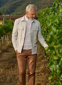 Consiglieri: light grey patch-pocket jacket with a grey roll-neck and brown trousers
