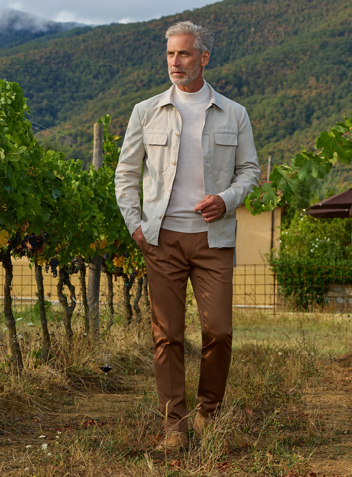 Consiglieri: light grey patch-pocket jacket with a grey roll-neck and brown trousers