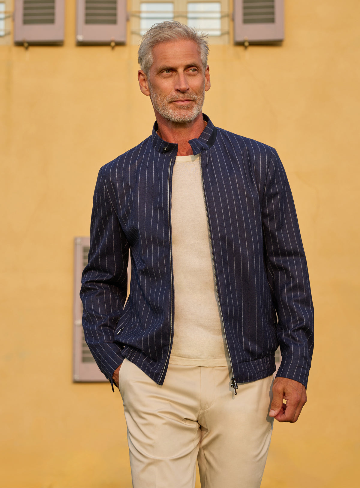 Consiglieri: navy pinstripe jacket with an ivory T-shirt and cream trousers