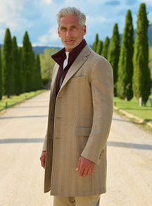 Consiglieri: camel overcoat with a contrasting burgundy collar and cream trousers