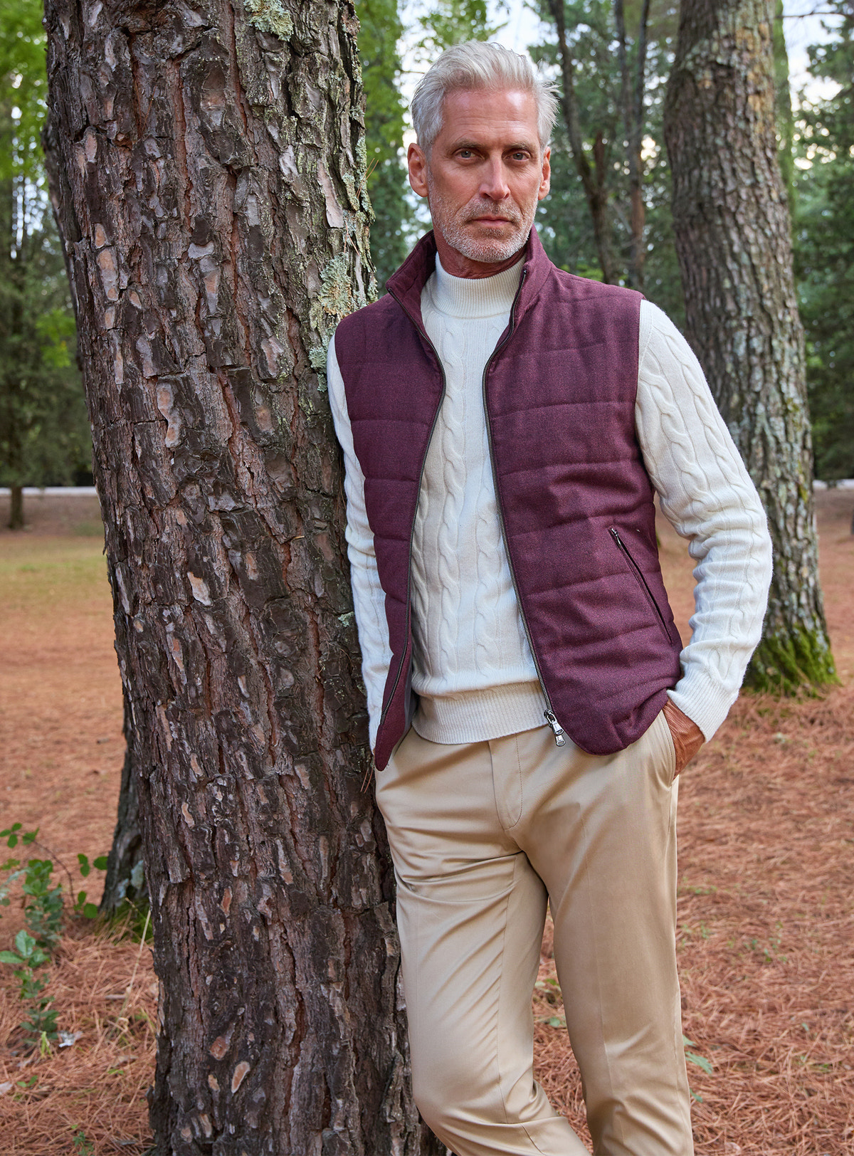 Consiglieri: ivory cable-knit sweater beneath a burgundy quilted gilet