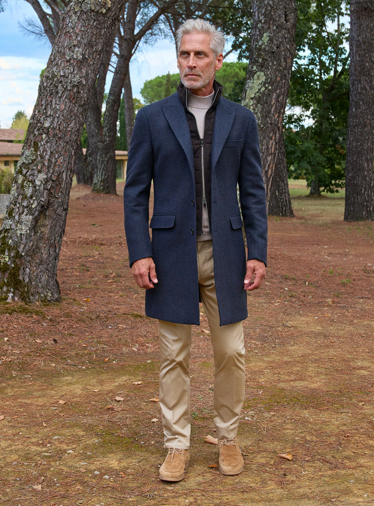 Consiglieri: navy overcoat with a grey roll-neck and beige trousers