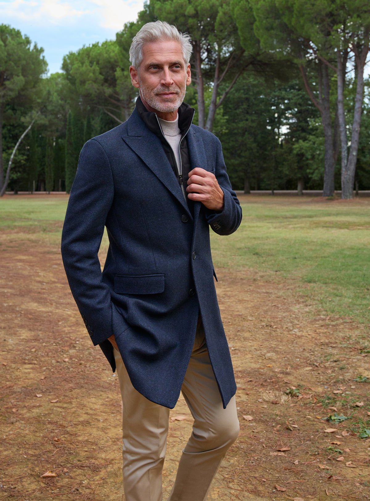 Consiglieri: navy overcoat with a grey roll-neck and beige trousers