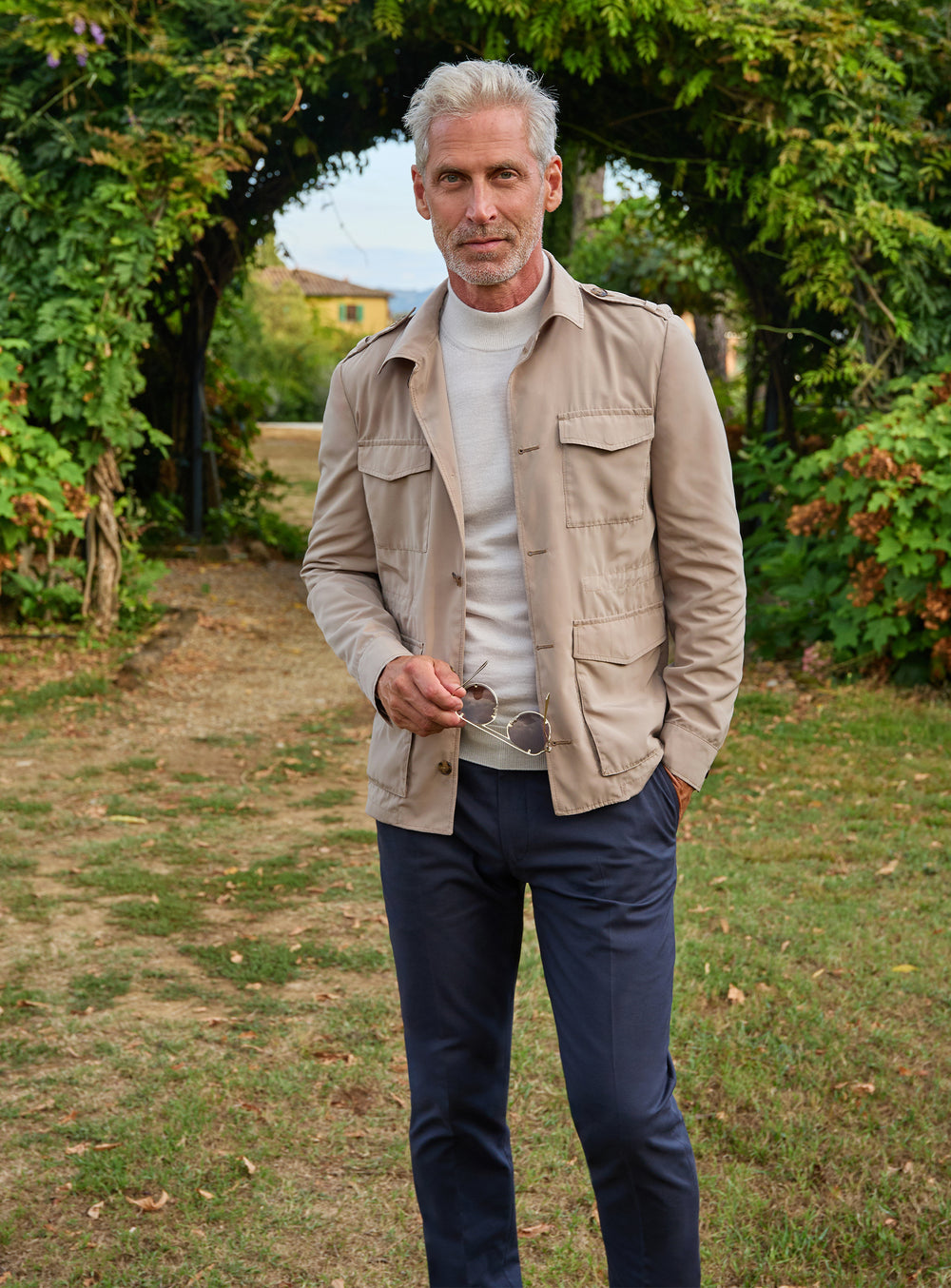 Consiglieri: beige patch-pocket jacket with a grey roll-neck and navy trousers