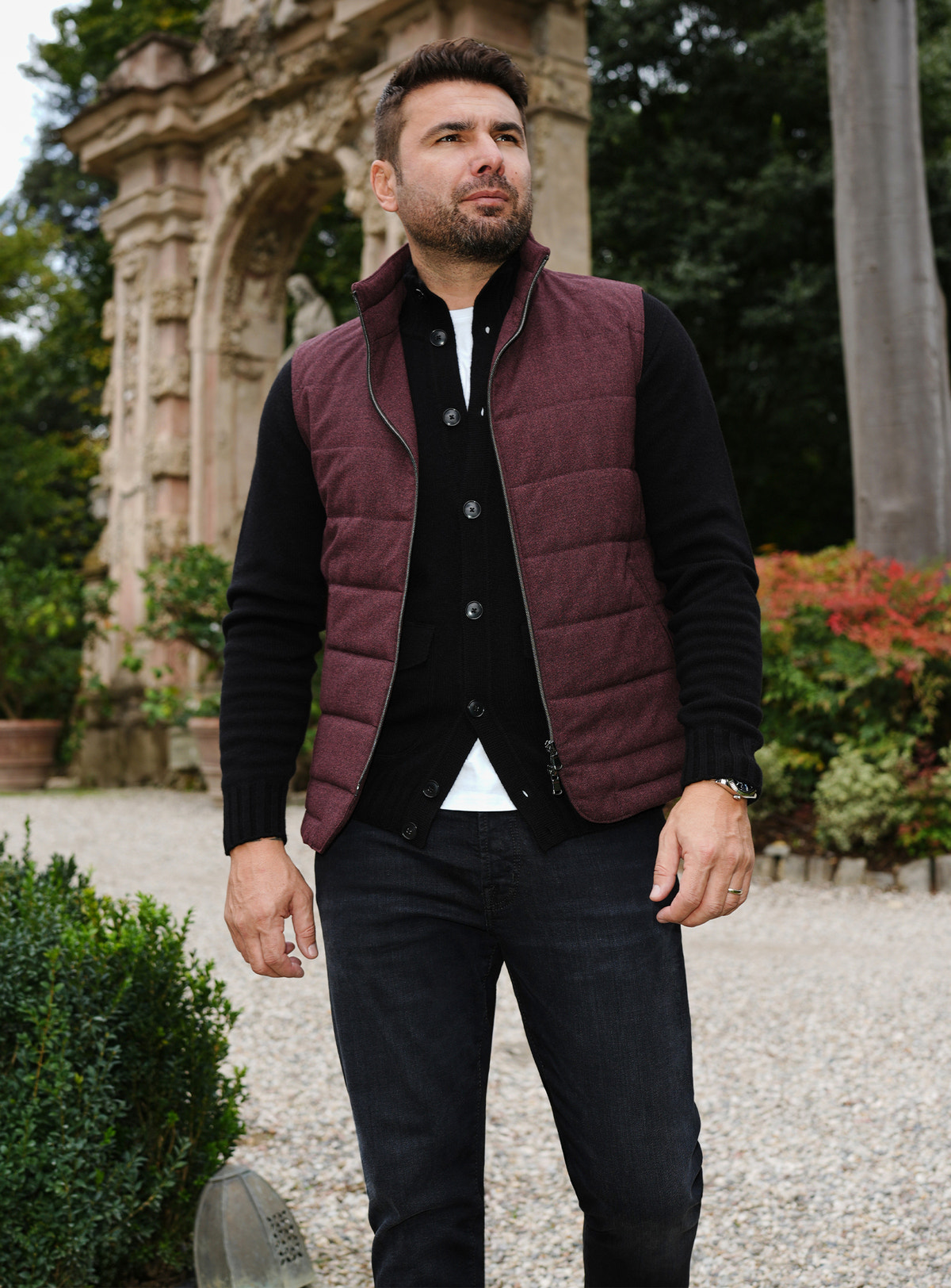 Burgundy quilted Consiglieri gilet layered over a black cardigan