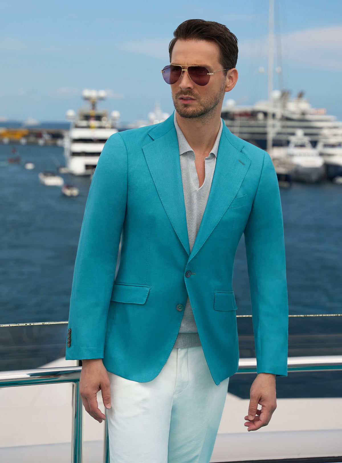 Turquoise Consiglieri jacket worn with a white shirt and ivory trousers