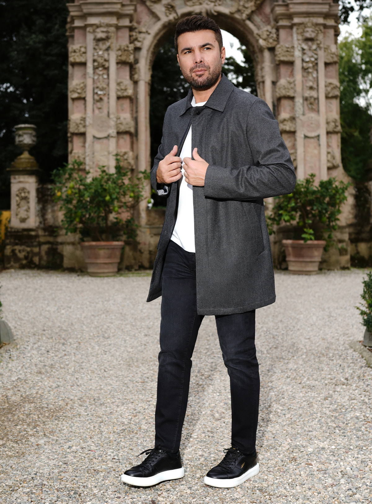 Black Consiglieri jeans worn with a charcoal coat
