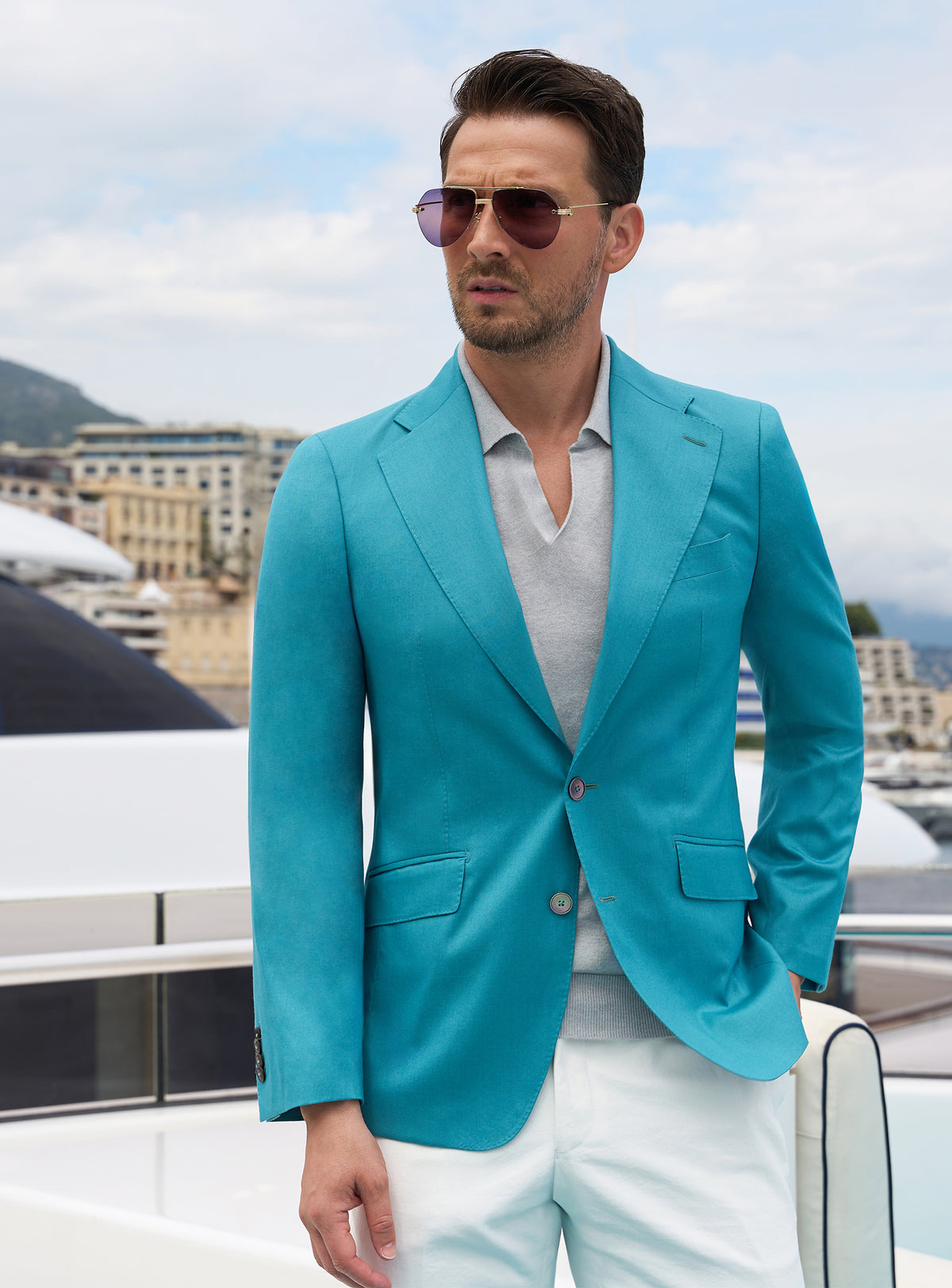 Turquoise Consiglieri jacket worn with a white shirt and ivory trousers