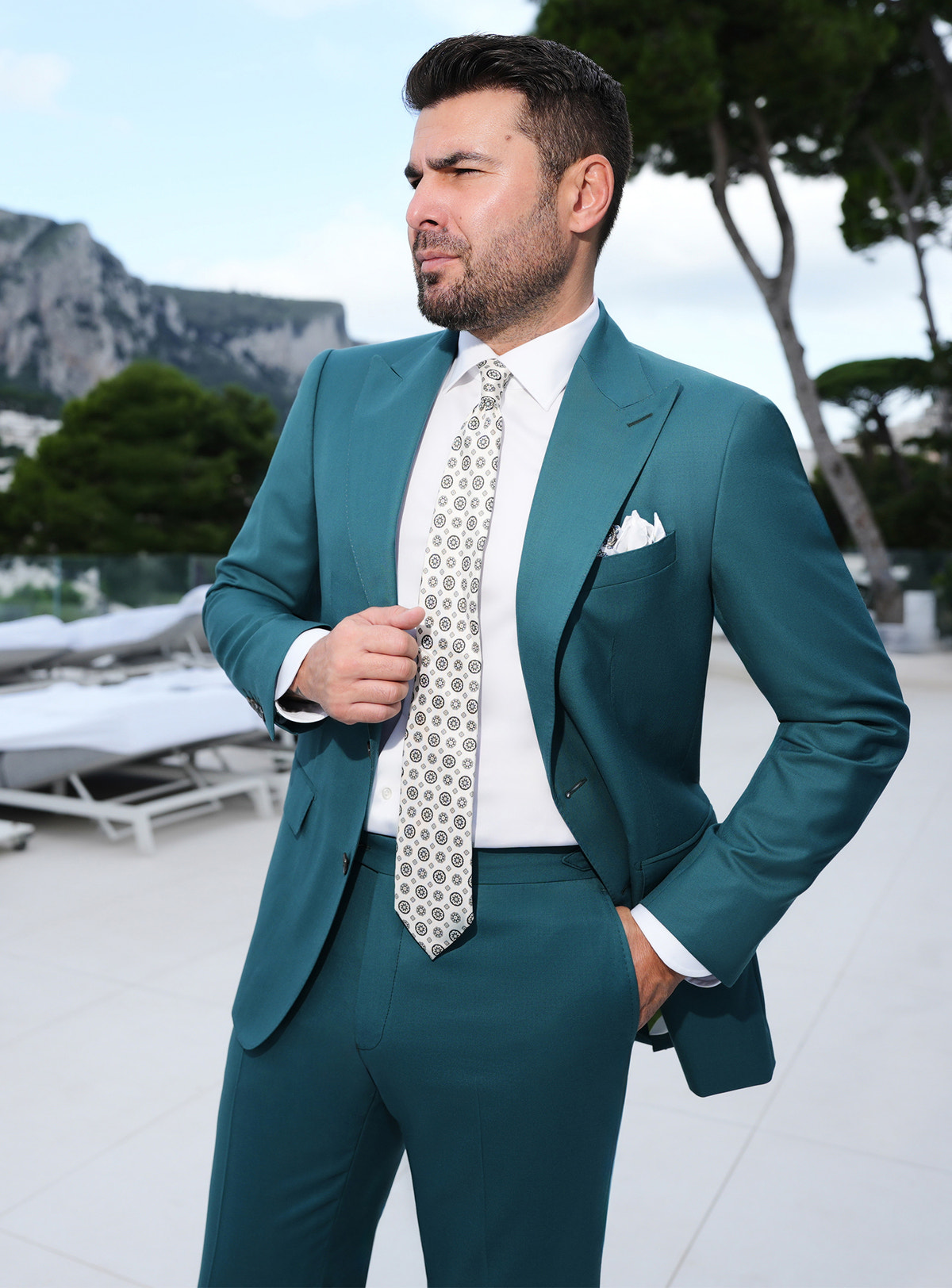 Teal Consiglieri suit worn with a white shirt and a light patterned tie