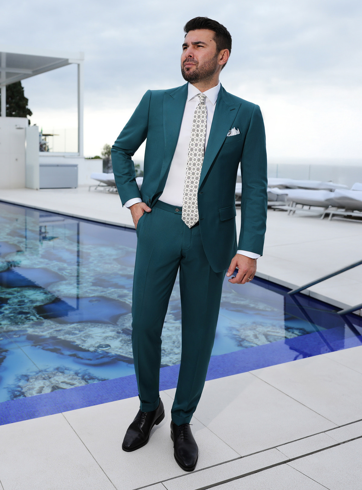 Teal Consiglieri suit worn with a white shirt and a light patterned tie