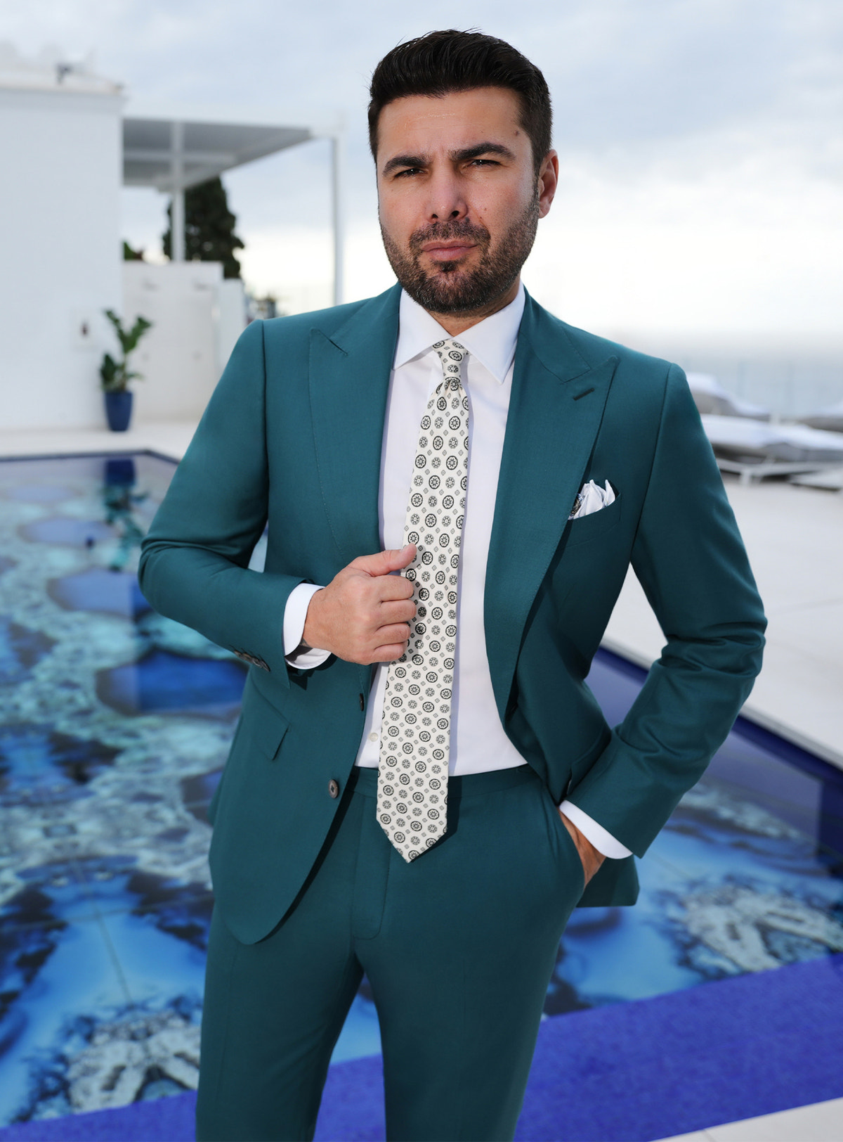 Teal Consiglieri suit worn with a white shirt and a light patterned tie