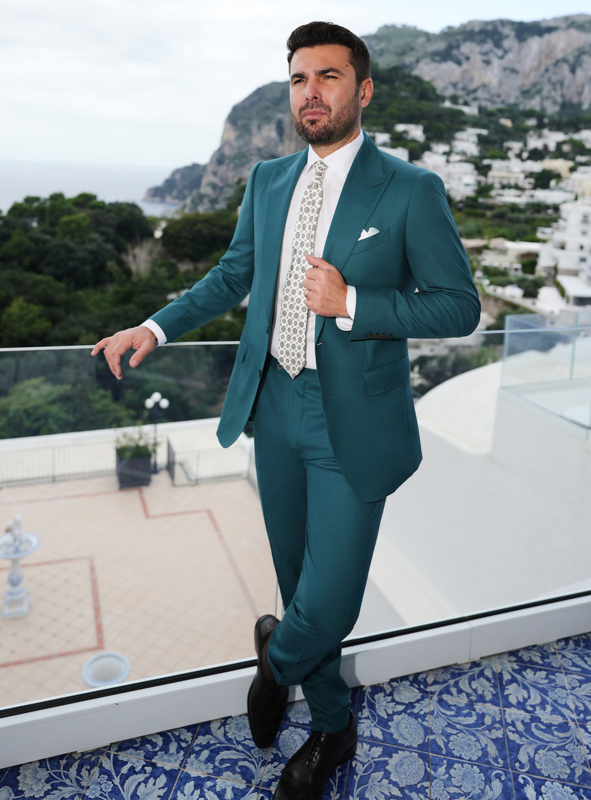 Teal Consiglieri suit worn with a white shirt and a light patterned tie