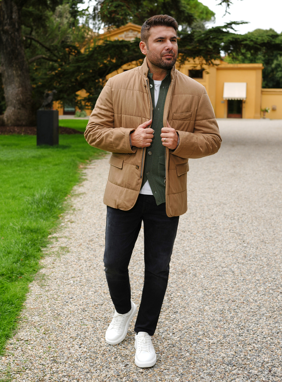 Black Consiglieri jeans with a camel quilted jacket and green cardigan