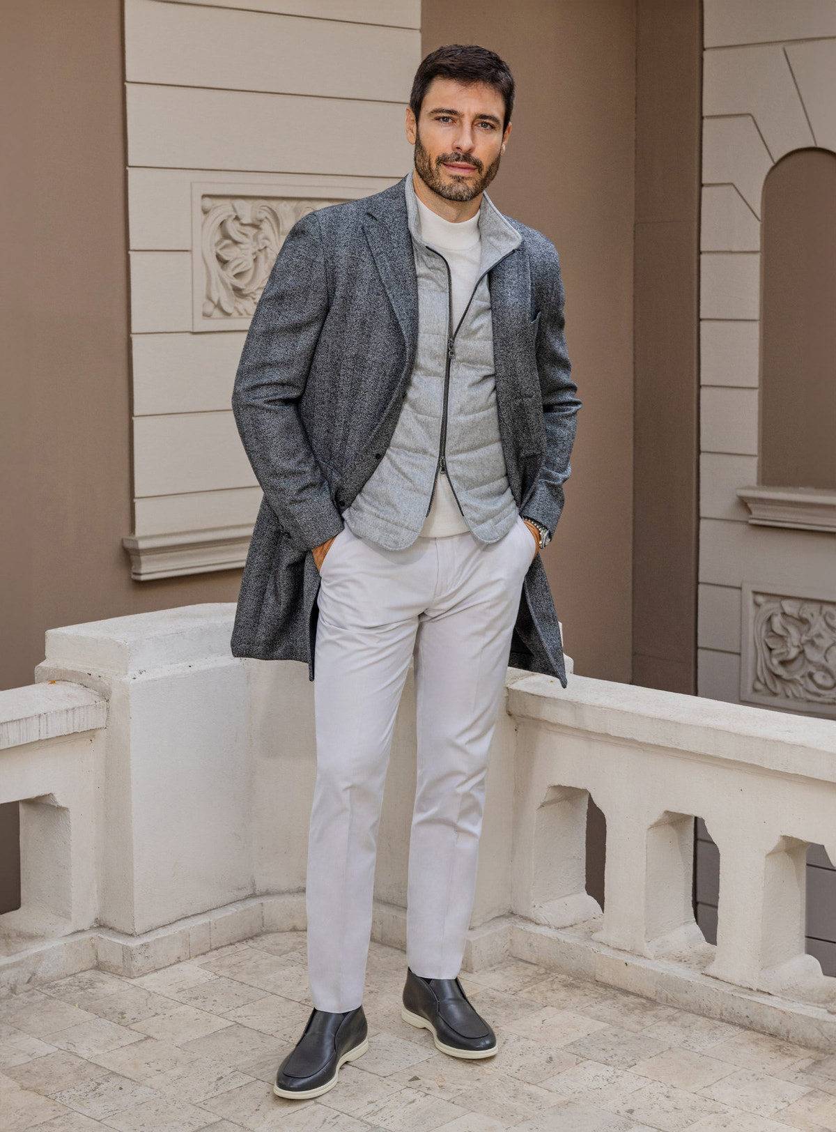 Consiglieri: light grey gilet beneath a grey checked overcoat, with ivory trousers