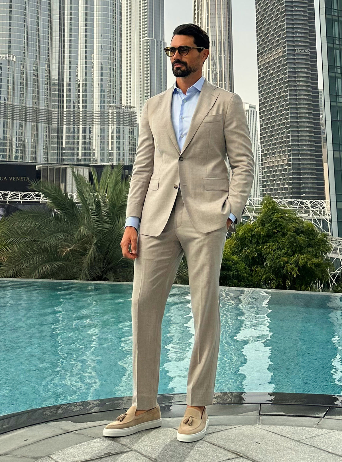 Light beige Consiglieri suit with a pale blue shirt and coordinated loafers