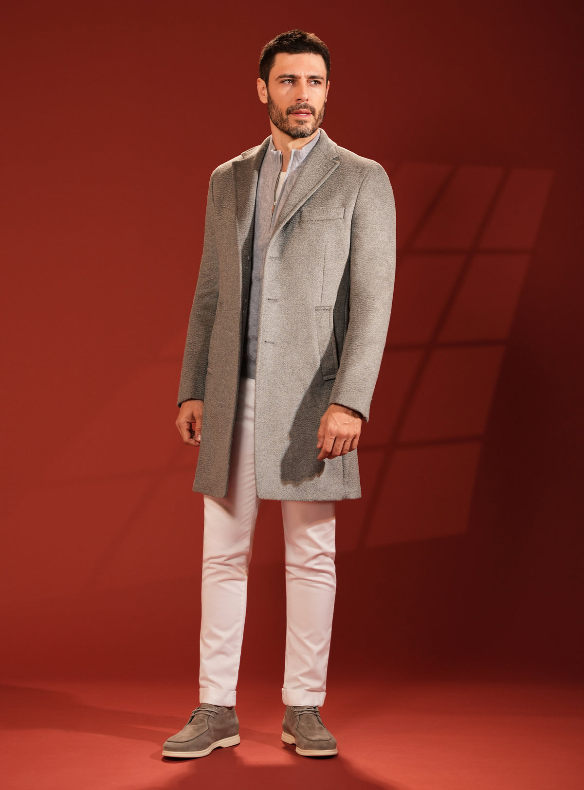 Grey-beige Consiglieri overcoat in a look with white trousers