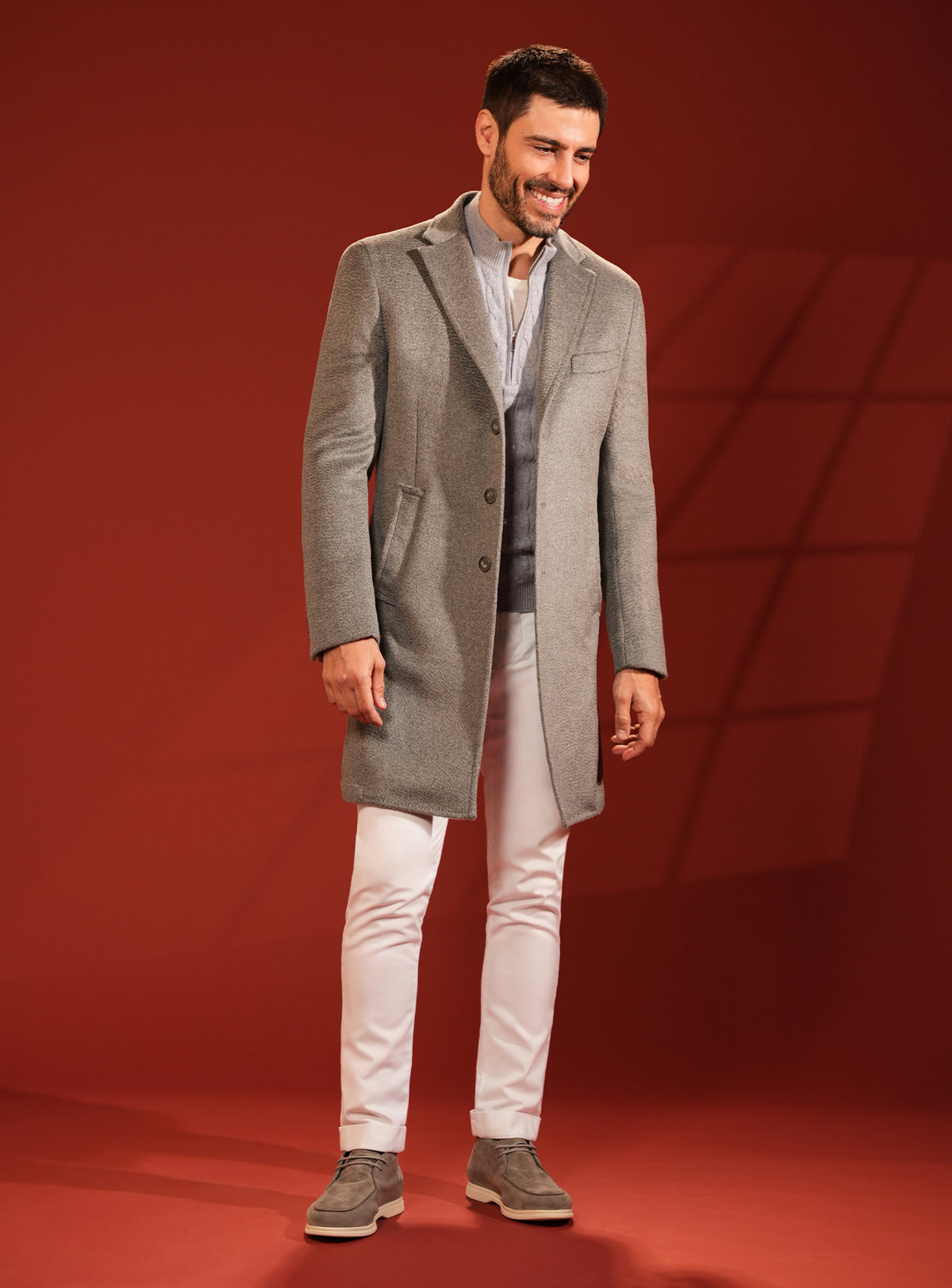 Grey-beige Consiglieri overcoat in a look with white trousers