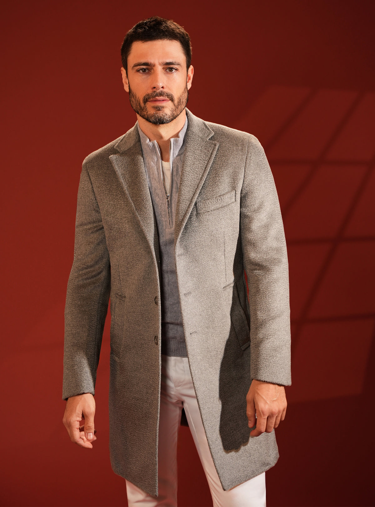 Grey-beige Consiglieri overcoat with a raised collar and light shirt
