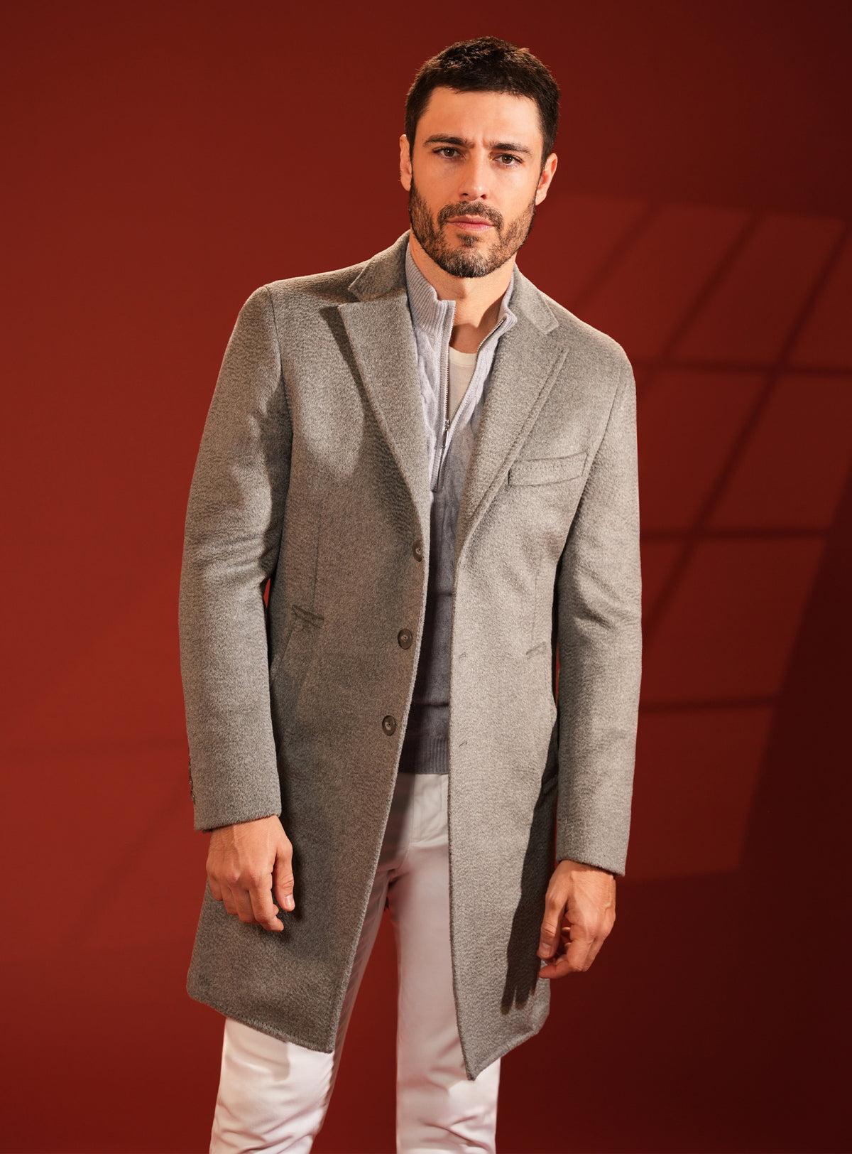 Grey-beige Consiglieri overcoat with a raised collar and light shirt
