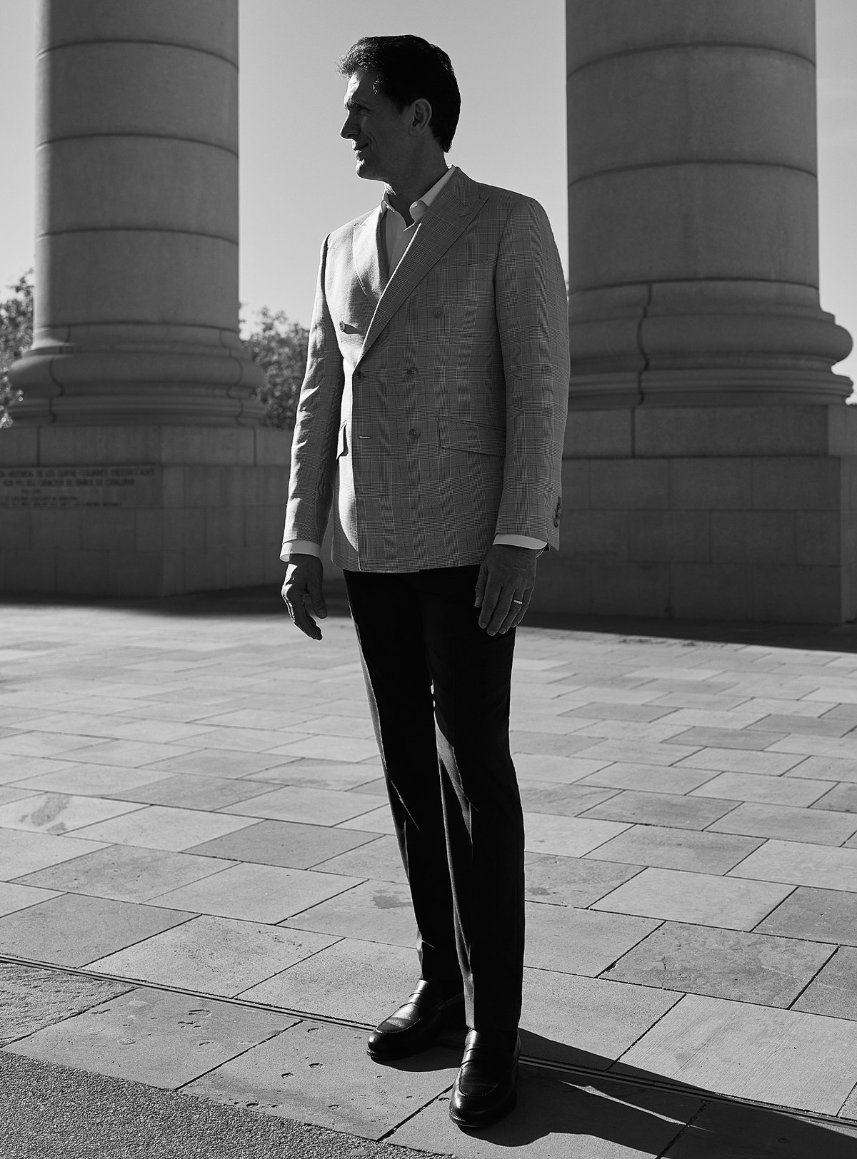 Double-breasted Consiglieri blazer and dark trousers in a black-and-white photograph