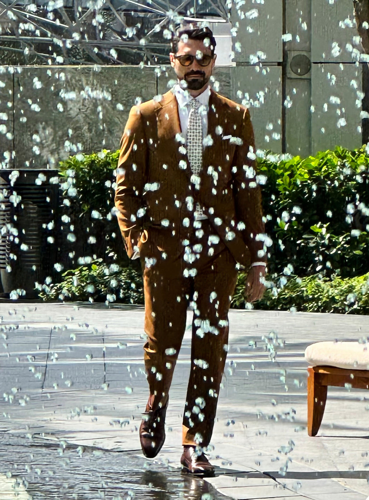 Ochre Consiglieri suit shown in motion in an urban setting
