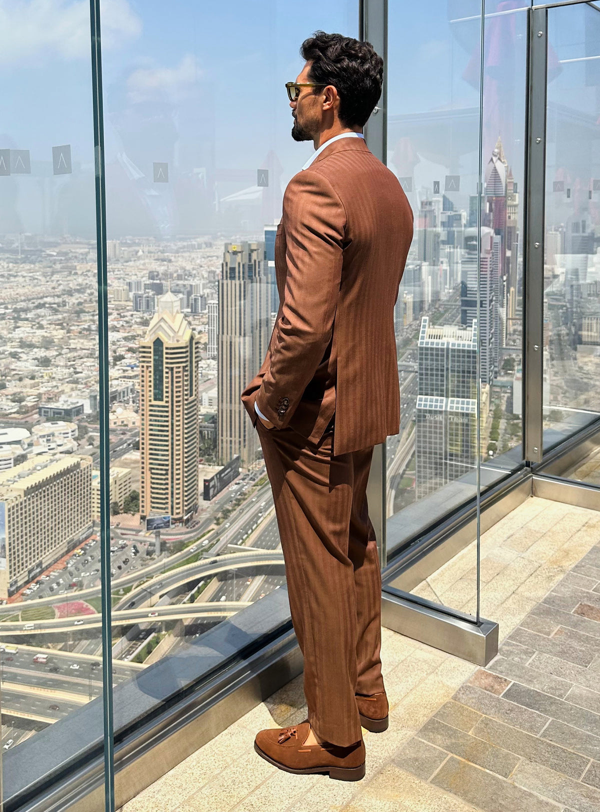 The back of a terracotta Consiglieri suit styled with brown loafers