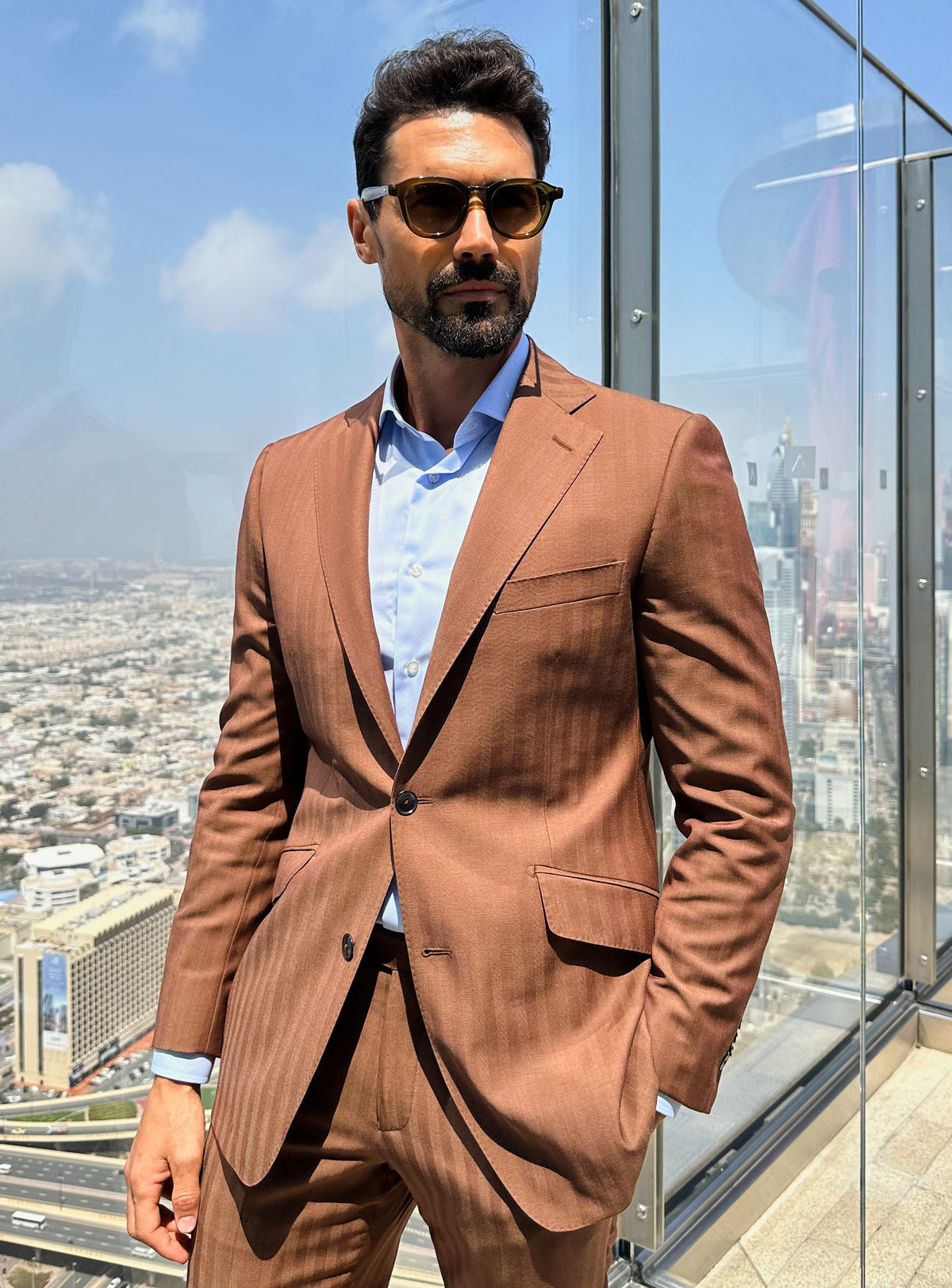 Terracotta Consiglieri jacket with lapels and pockets outlined by natural light