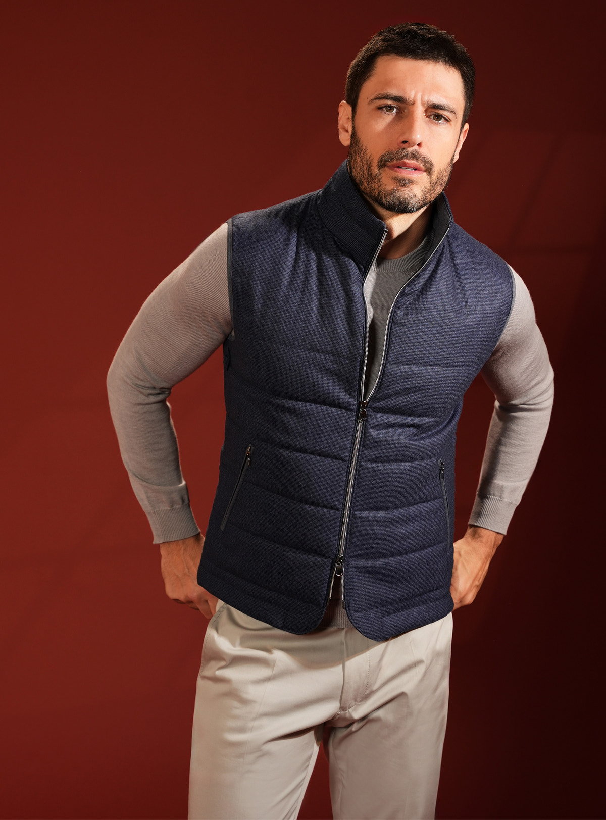 Navy quilted Consiglieri vest with a raised collar over a grey sweater
