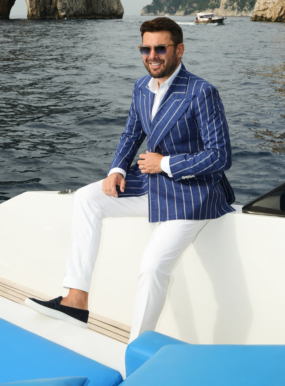 Navy double-breasted Consiglieri blazer with white stripes, worn with white trousers