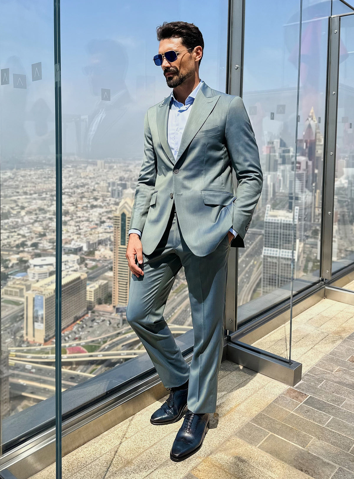 Consiglieri suit in blue-green tones styled with dark shoes