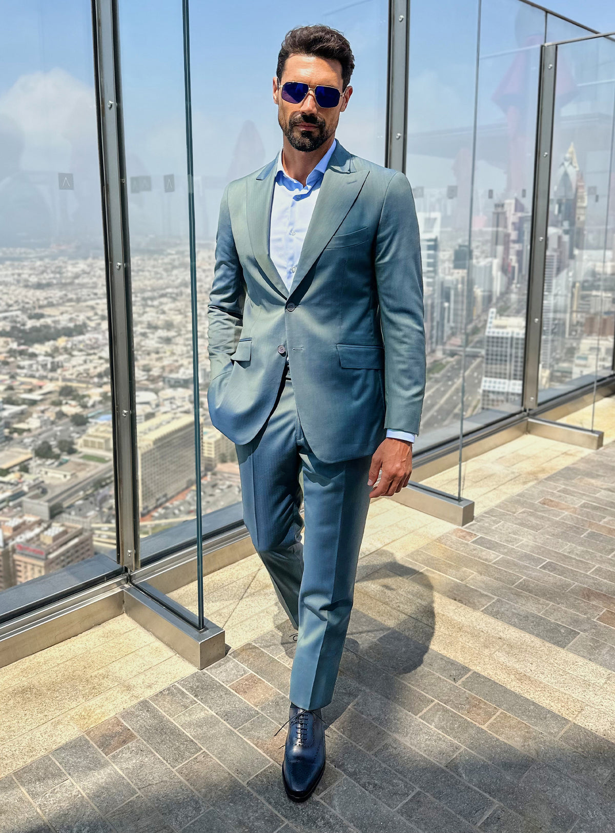 Consiglieri suit in blue-green tones styled with dark shoes